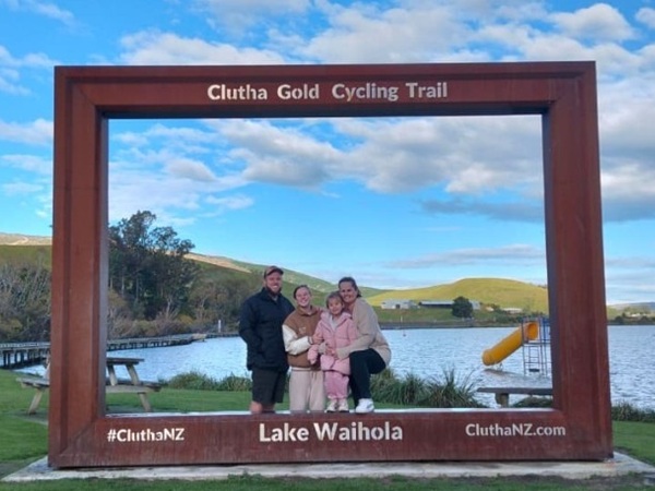 Photo of a family in a giant picture frame in New Zealand. NZ Skills in Demand case study of moving and working in New Zealand as a scaffolder